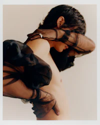 a naked woman with a veil covering her face