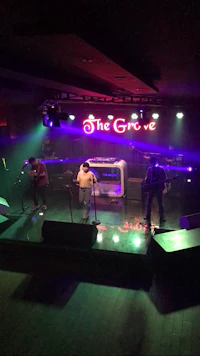 a group of people on stage at the grove