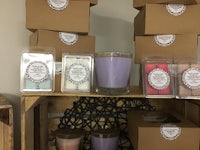 a display of candles in boxes on a shelf