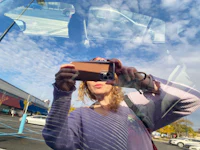 a woman taking a selfie in a car window