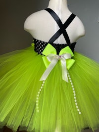 a lime green tutu dress with a black bow