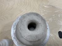 a clay pot with a hole in it on a table