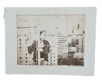 a photo of a man on a pole in a city