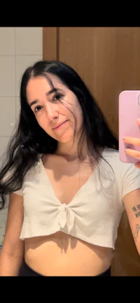 a woman taking a selfie in a bathroom