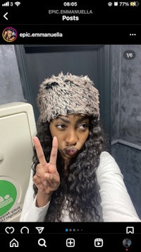 a woman is making a peace sign on her phone