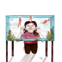 a girl sitting in front of a fish tank with fish in it