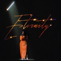 a woman in an orange dress standing in front of a spotlight