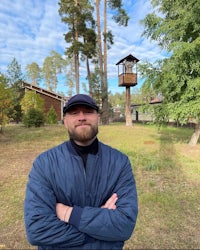 a man standing in front of a tree house