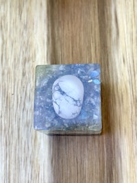 a white stone is sitting on top of a wooden table