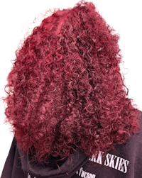 the back of a woman with curly red hair