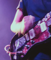 a man playing an electric guitar on stage