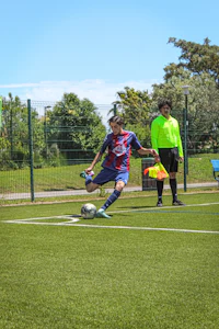 a man kicking a soccer ball