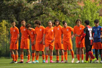 a group of soccer players standing in a line
