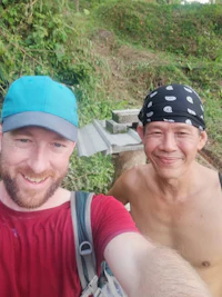 two men taking a selfie on a trail