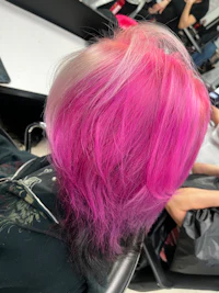 a woman with pink hair in a salon