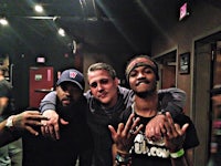 three men posing for a picture in a club