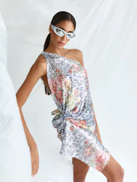 the model is wearing a floral dress and sunglasses