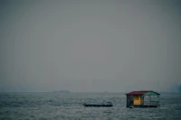 a small house in the middle of a body of water