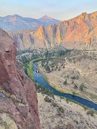 a person is jumping off a cliff into a river