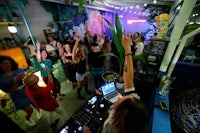 a group of people at a party with a dj