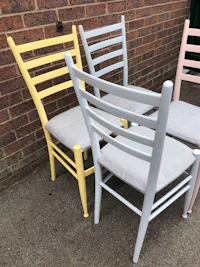 a set of four chairs painted in different colors