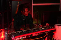 a man with dreadlocks playing a keyboard