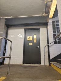 the entrance to a subway station has a sign on it
