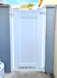 a white gate with white paint on it