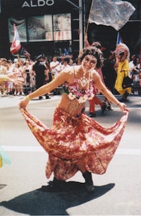 a woman in a dress dancing in a parade