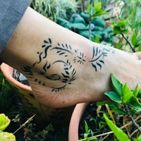 a person's foot with a tattoo on it