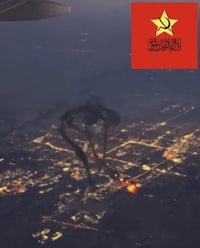 an airplane flying over a city at night