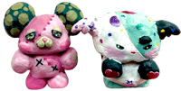 a pair of teddy bears with polka dots on their faces