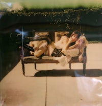a photo of two women laying on a couch