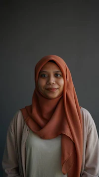 a woman in a hijab smiling for the camera