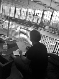 a man sitting on a couch with a notebook in front of him