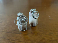 a pair of earrings with a star and moon in them