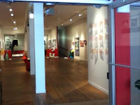 a red door leads into an art gallery