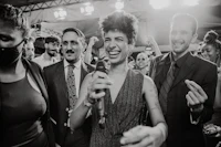 a man is holding a microphone in front of a group of people