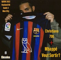 a man holding up a barcelona fc shirt