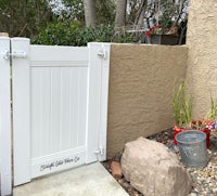 a white gate in front of a house