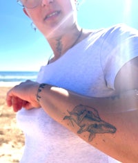 a woman with a tattoo on her arm