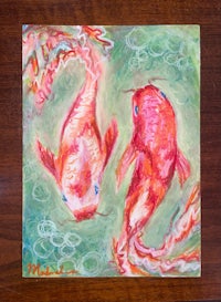 a painting of two koi fish on a table