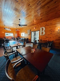 a dining room with tables and chairs in a log cabin