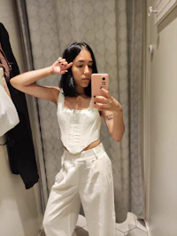 a woman is taking a selfie in a mirror