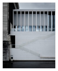 a white building with a staircase in front of it