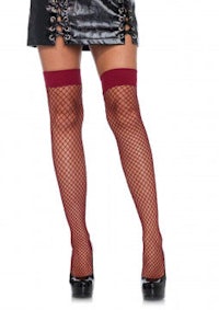 a woman wearing fishnet stockings and a leather skirt