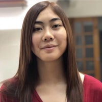 a young asian woman in a red top