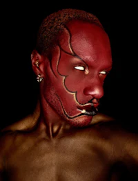 a man with red paint on his face
