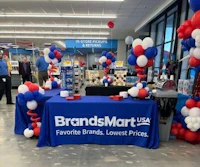 a table with red, white and blue balloons in a store