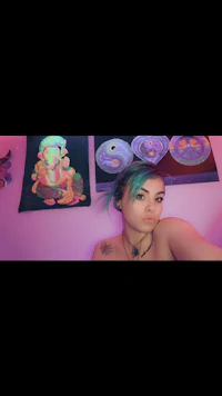 a girl is taking a selfie in a pink room